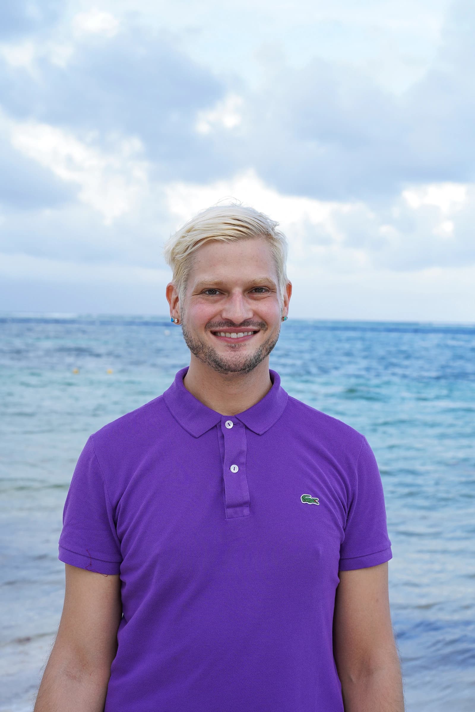 Dr. Derek Austin smiling in a purple polo