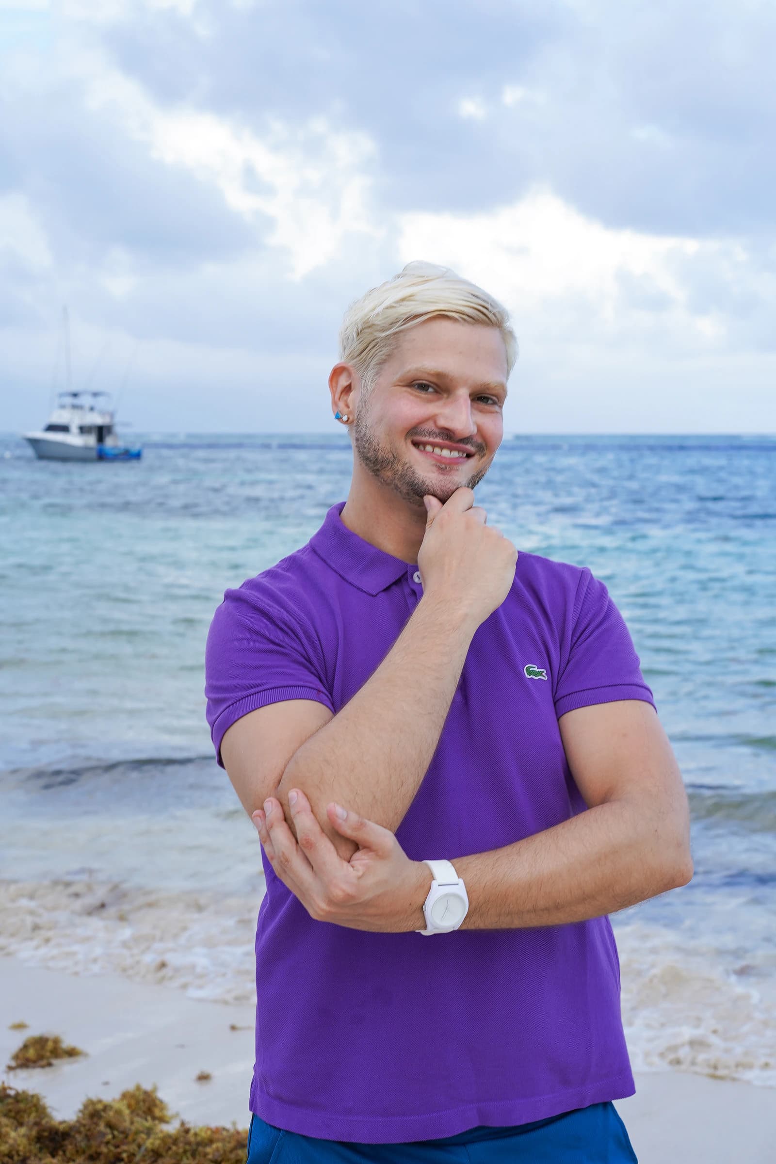 Dr. Derek Austin posing thoughtfully in a purple polo